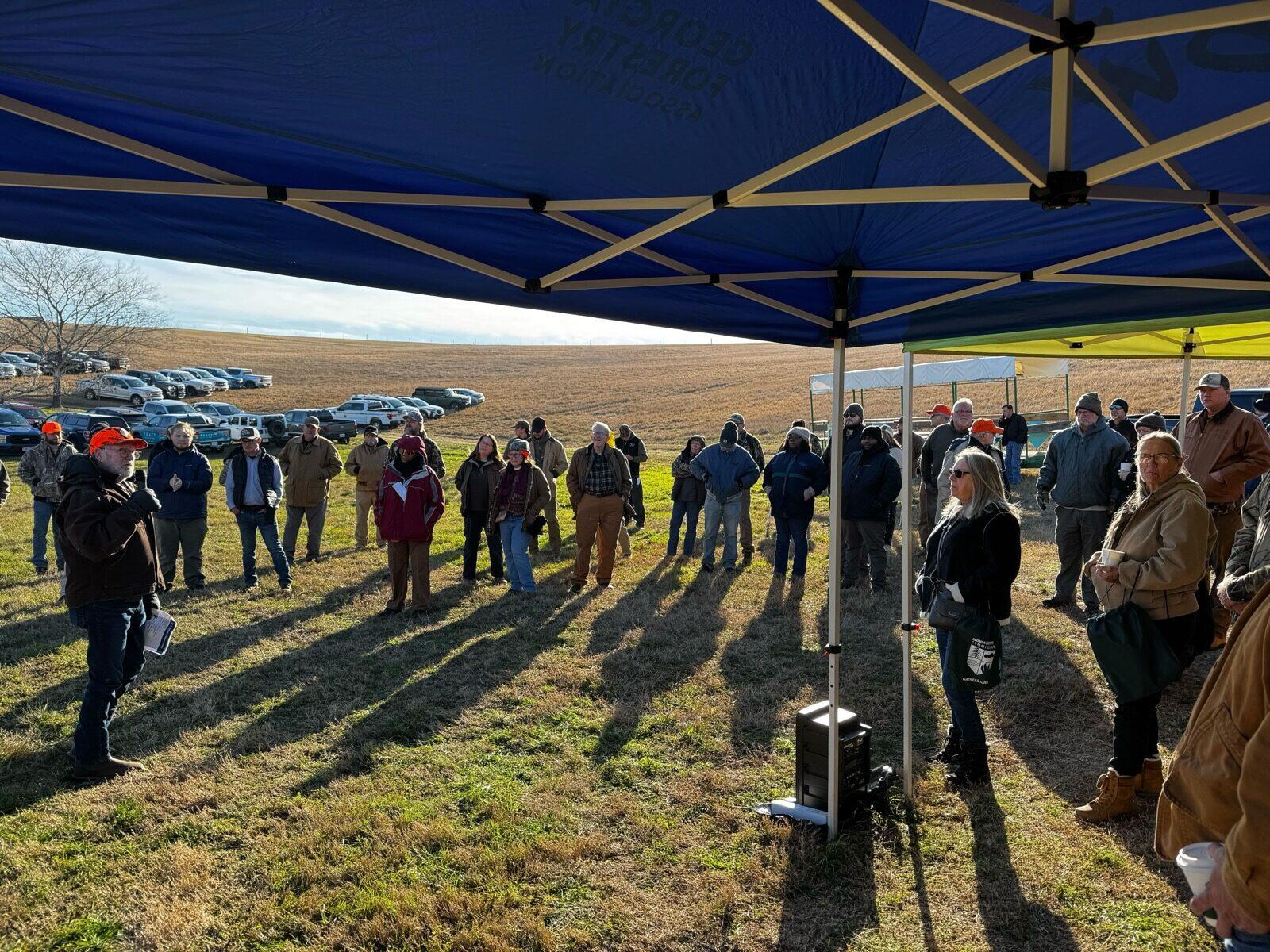 Landowners gathered under a tent at the start of the GFA Field Day