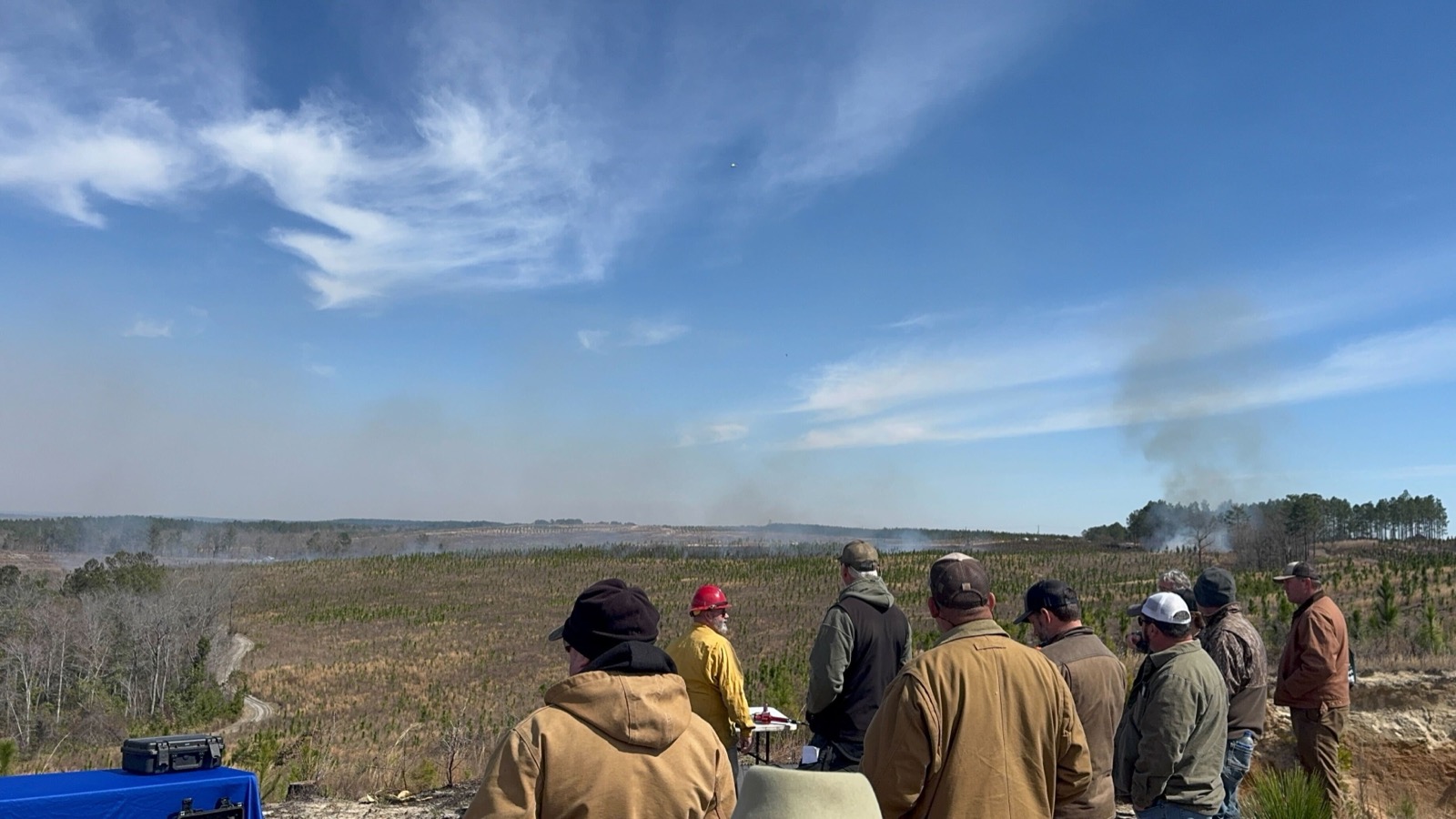 Attendees watching a prescribed burn from an overlook at the GFA Landowner Field Day in Butler, Georgia